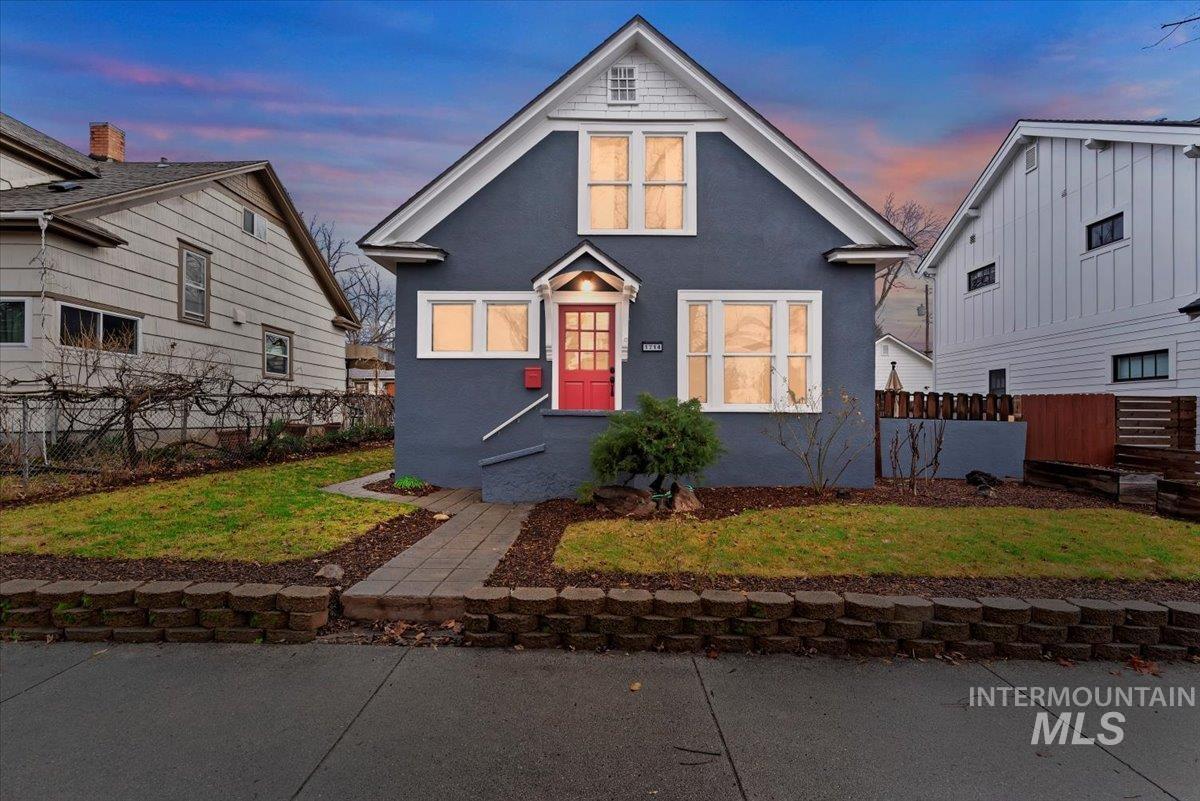 Bungalow-style home with stucco siding
