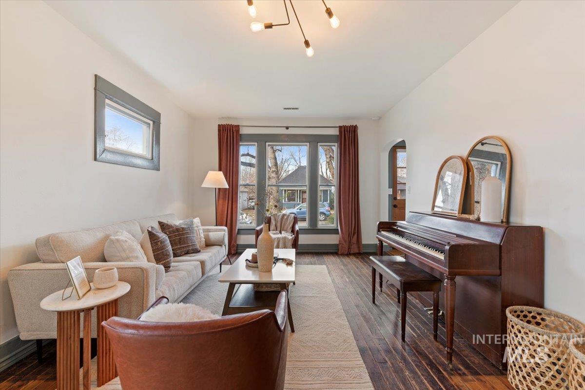Living room featuring dark wood finished floors and arched walkways