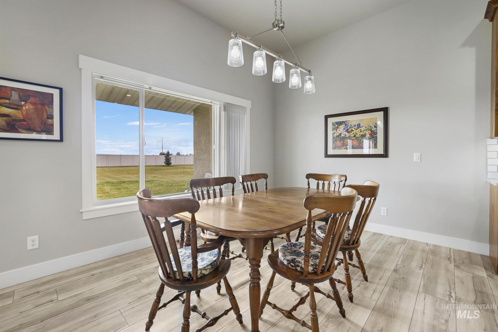 Dining area with light wood-style floors