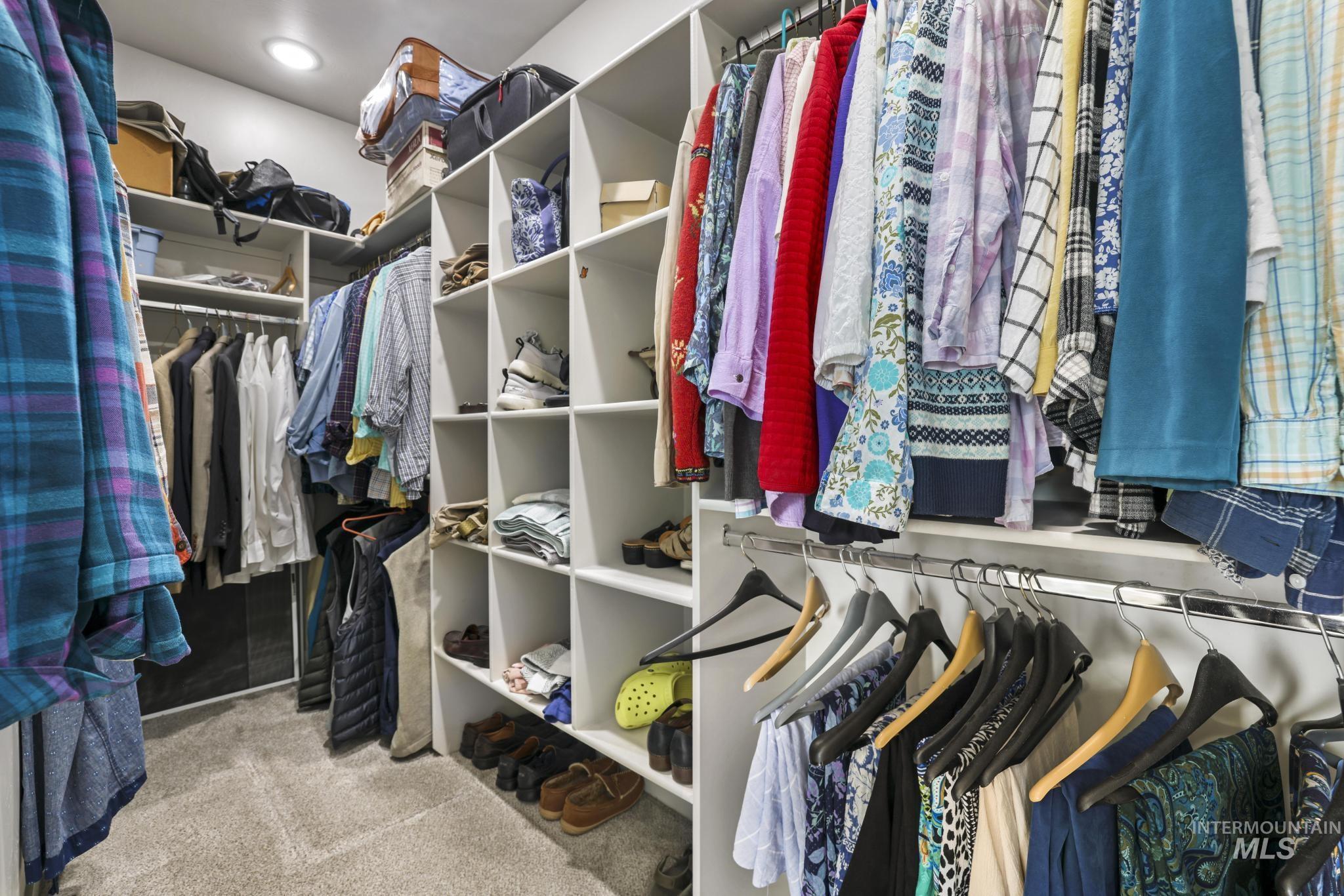 Walk in closet featuring light carpet