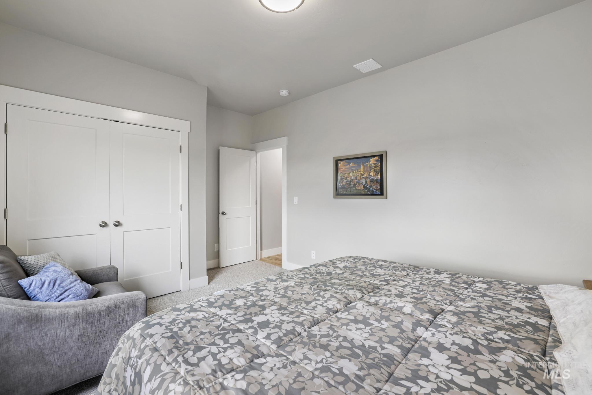 Bedroom with a closet and light carpet