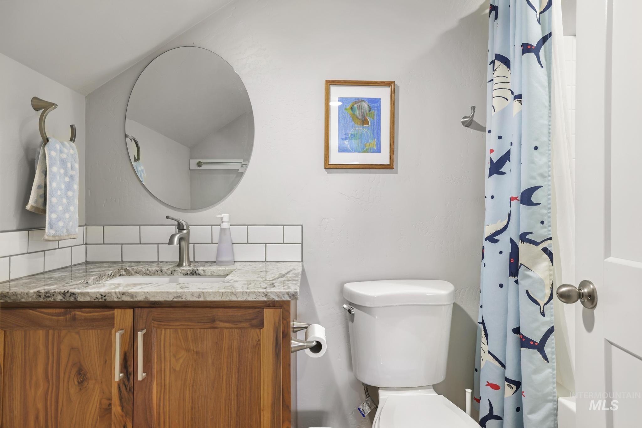 Full bath with vanity and curtained shower