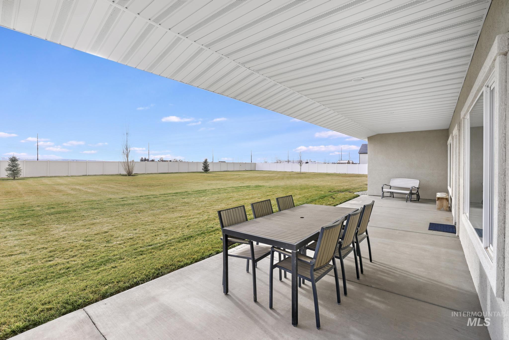 Fenced backyard featuring a patio area and outdoor dining space