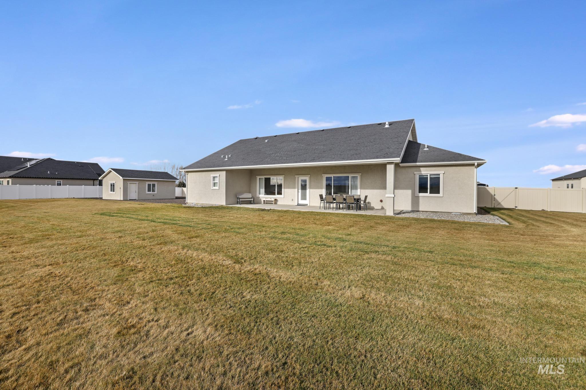 Back of property with a patio and stucco siding