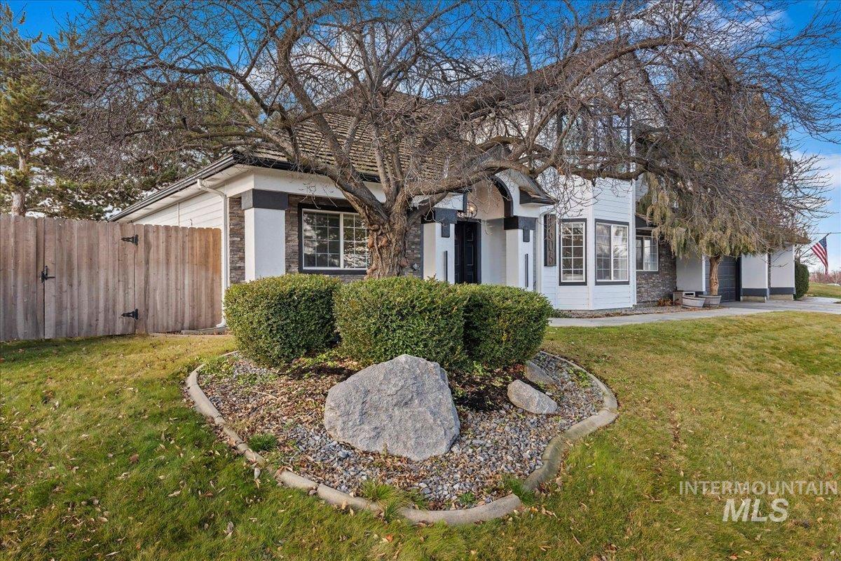 View of front facade with a gate and stone siding