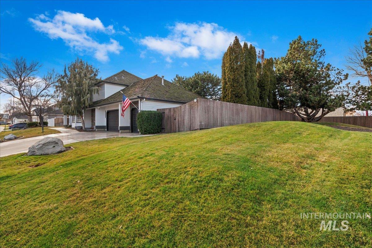View of home's exterior featuring a garage and concrete driveway