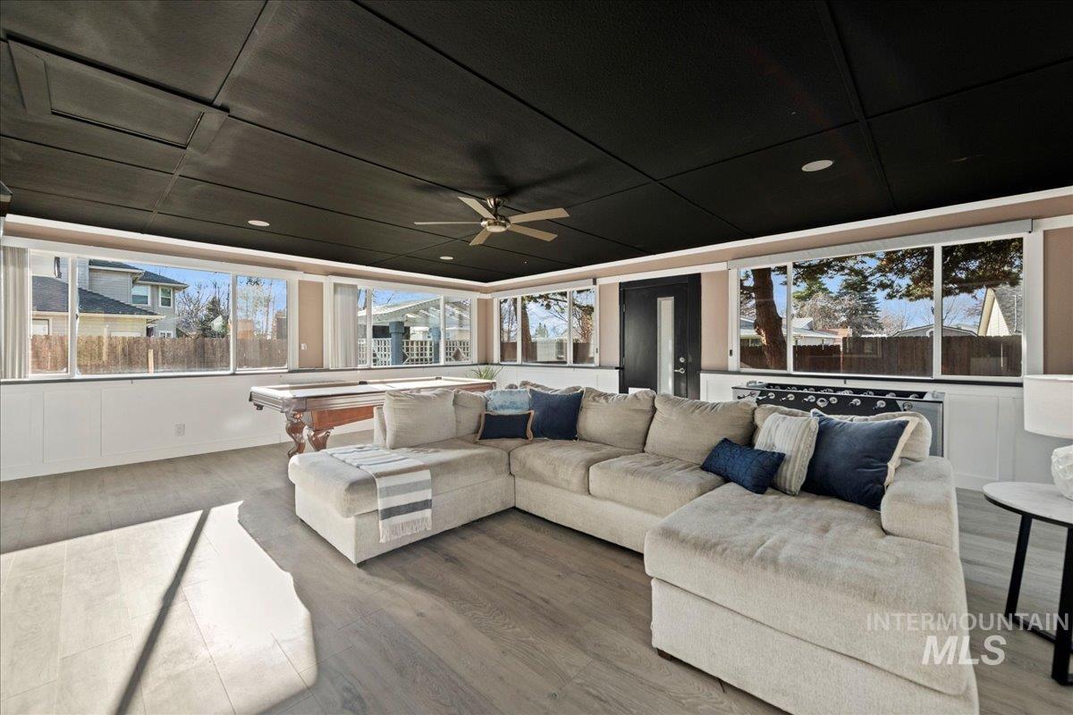 Sunroom / solarium featuring wood finished floors