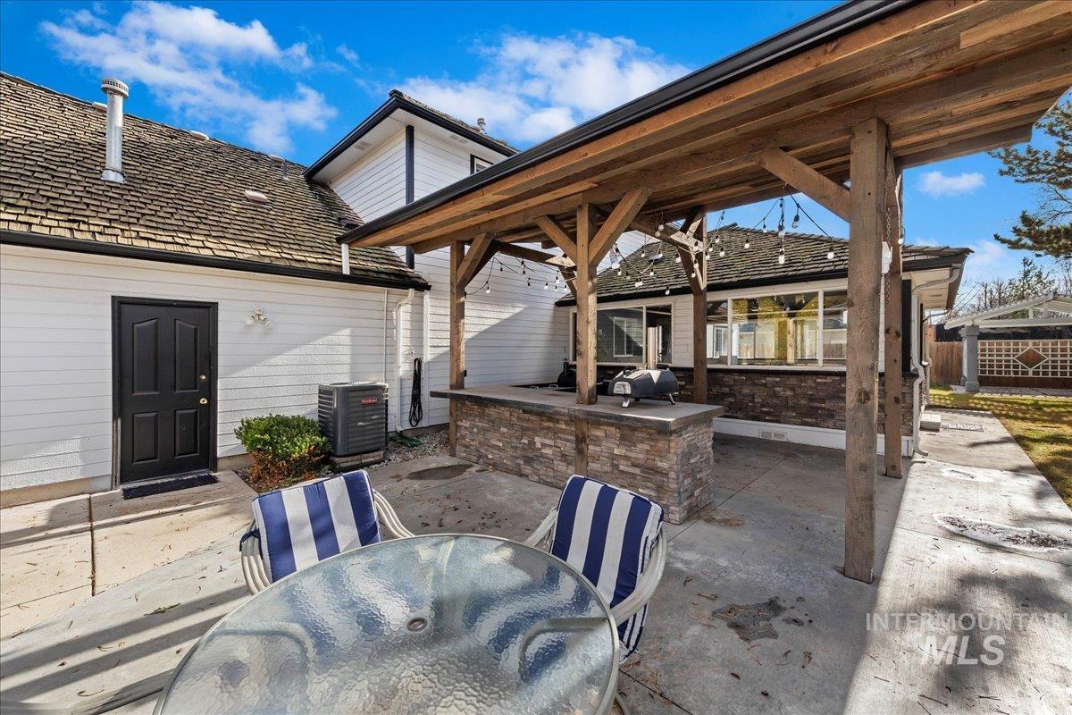 View of patio featuring outdoor dining area and an outdoor kitchen