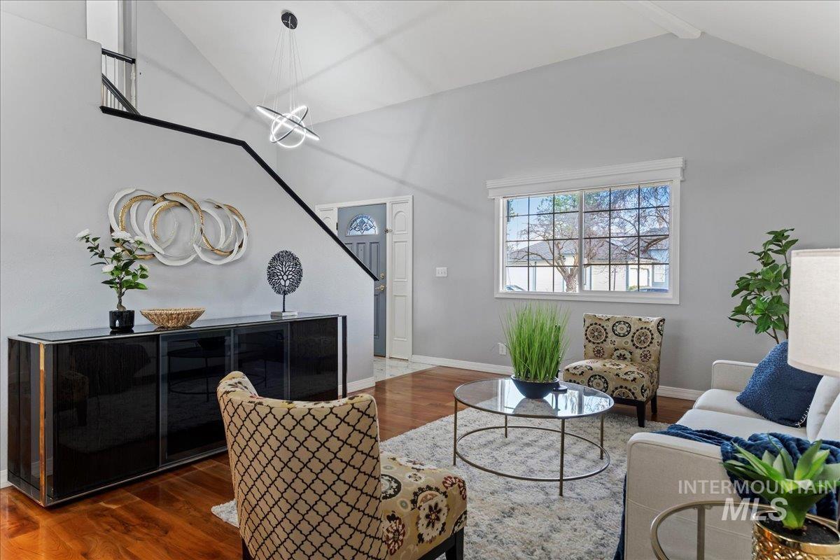 Living area with high vaulted ceiling and wood finished floors