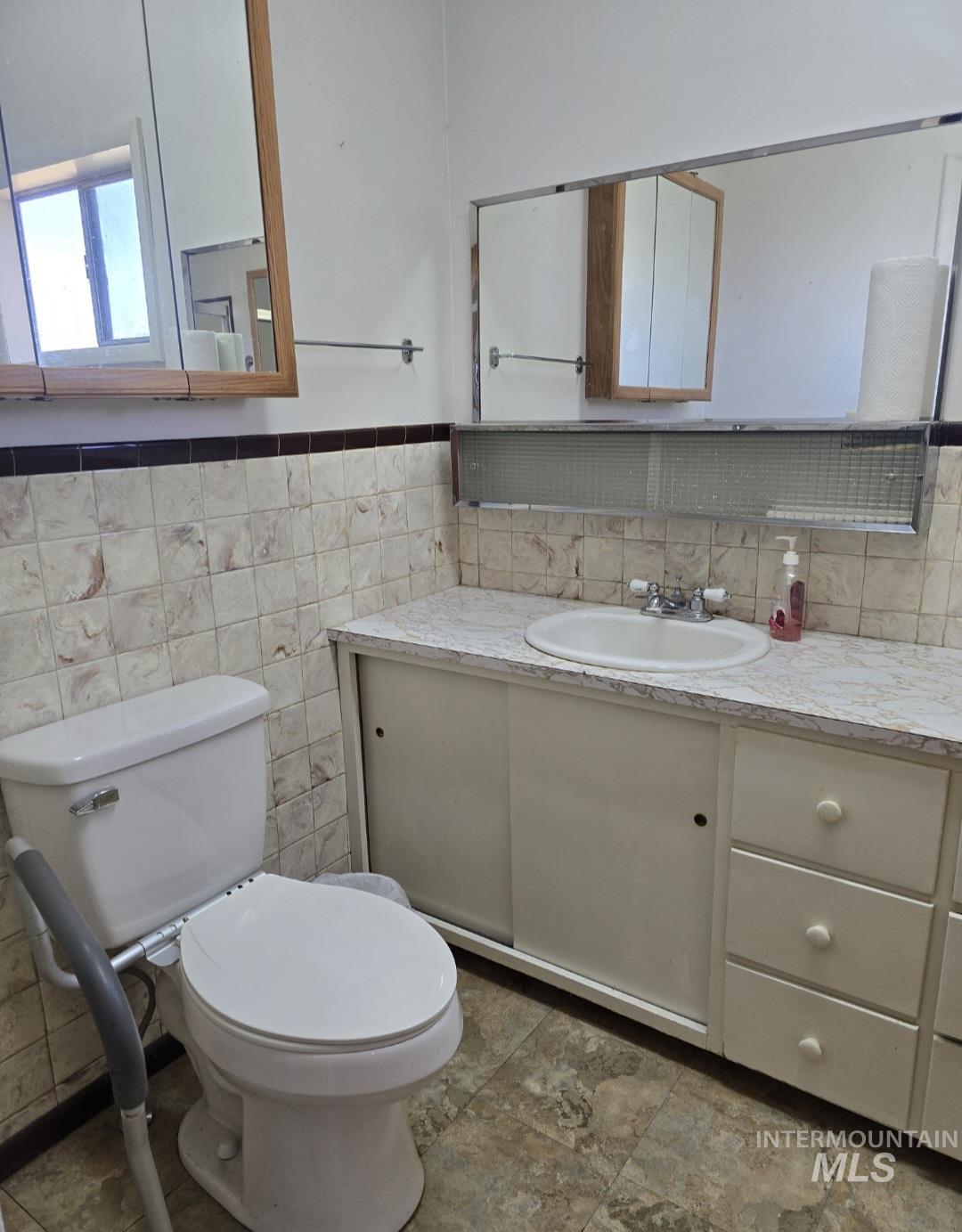Half bath featuring toilet and vanity
