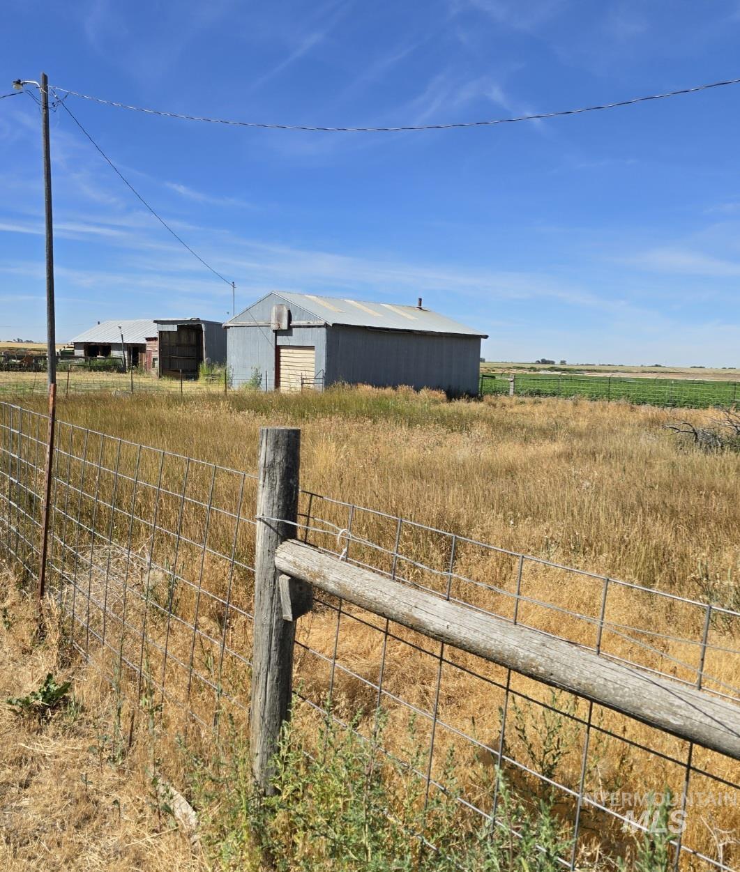 View of yard with a pole building, an outdoor structure, and a view of countryside