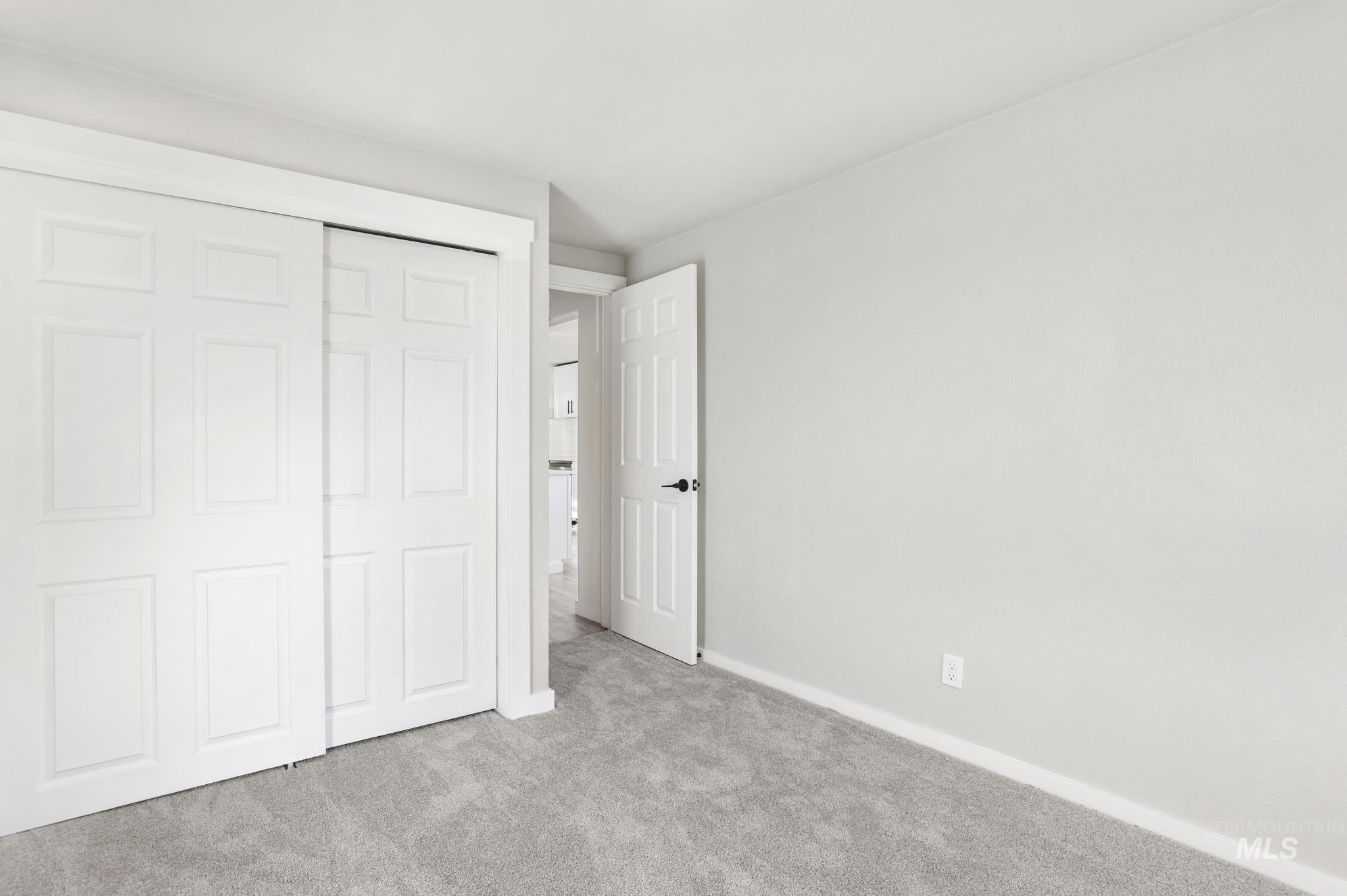 Unfurnished bedroom featuring carpet floors and a closet