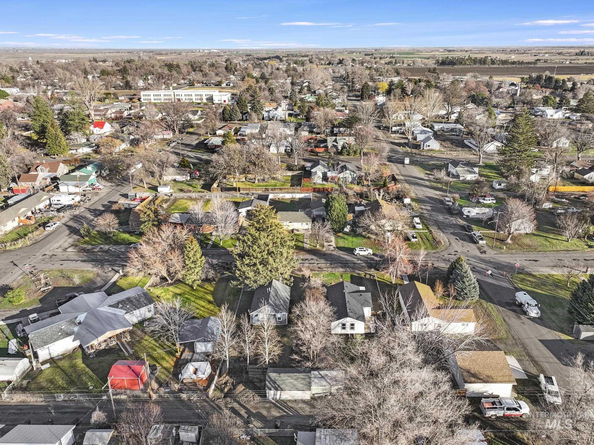 Aerial view of property and surrounding area with nearby suburban area