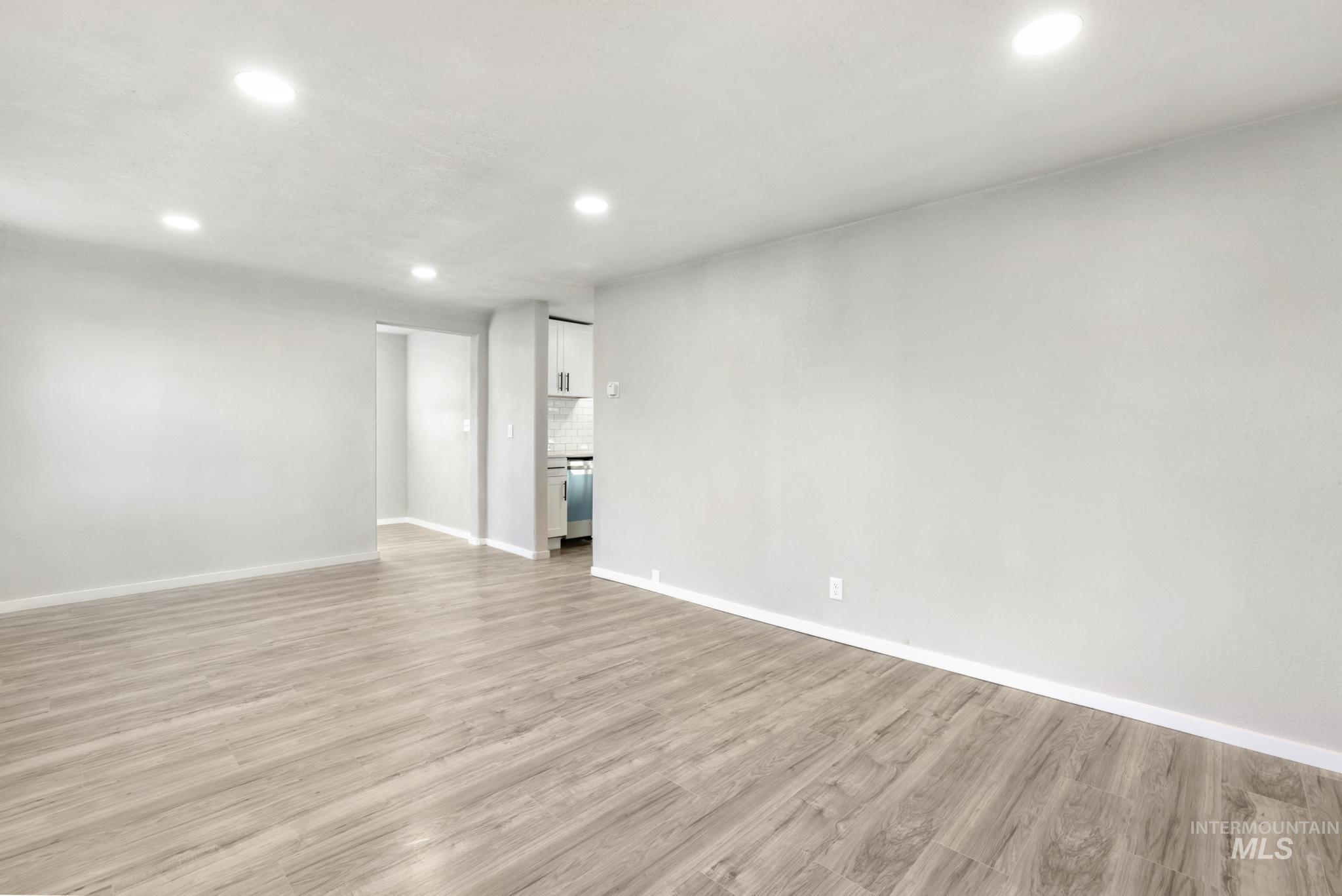 Unfurnished living room featuring recessed lighting and light wood-style flooring