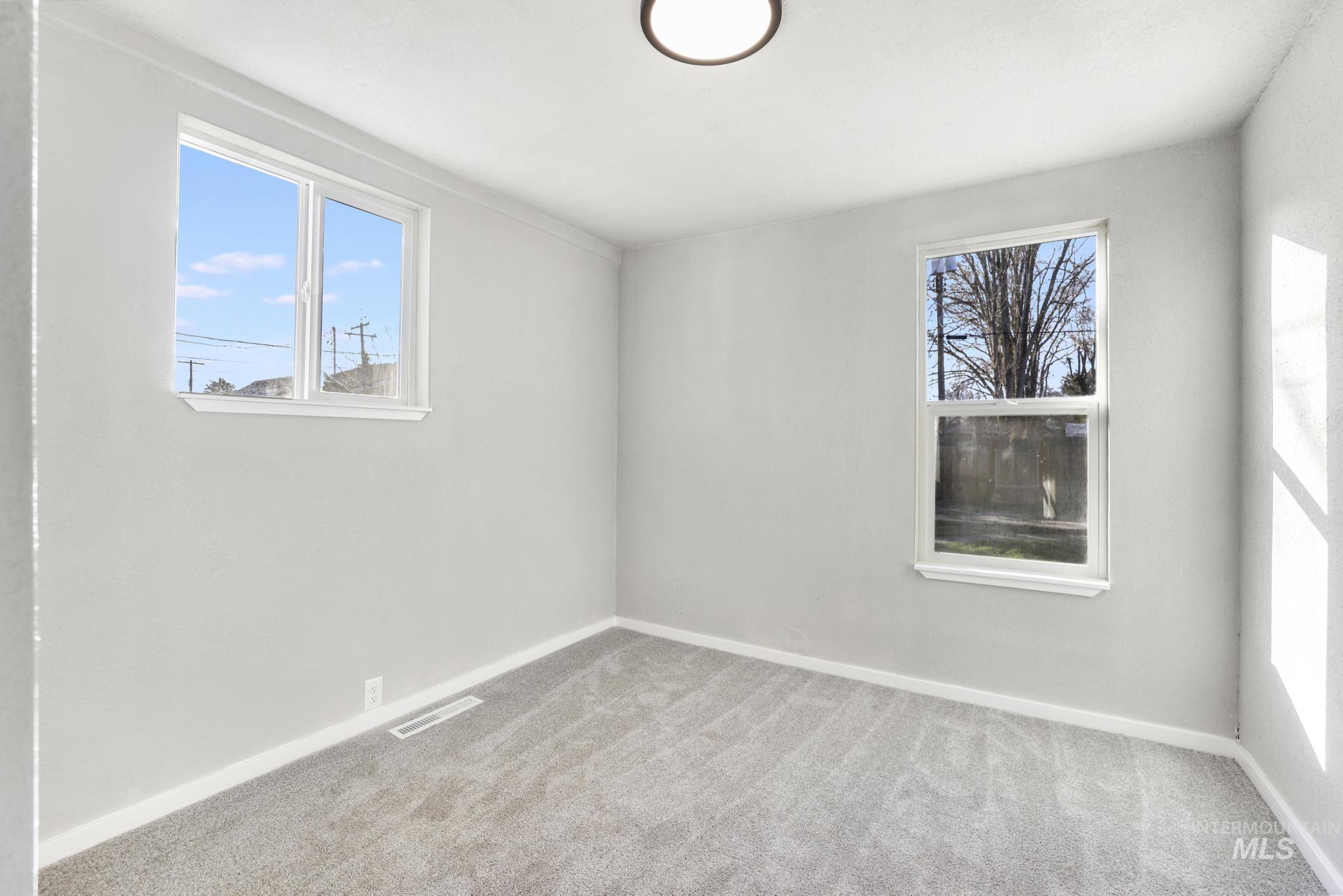 Empty room featuring carpet floors and baseboards