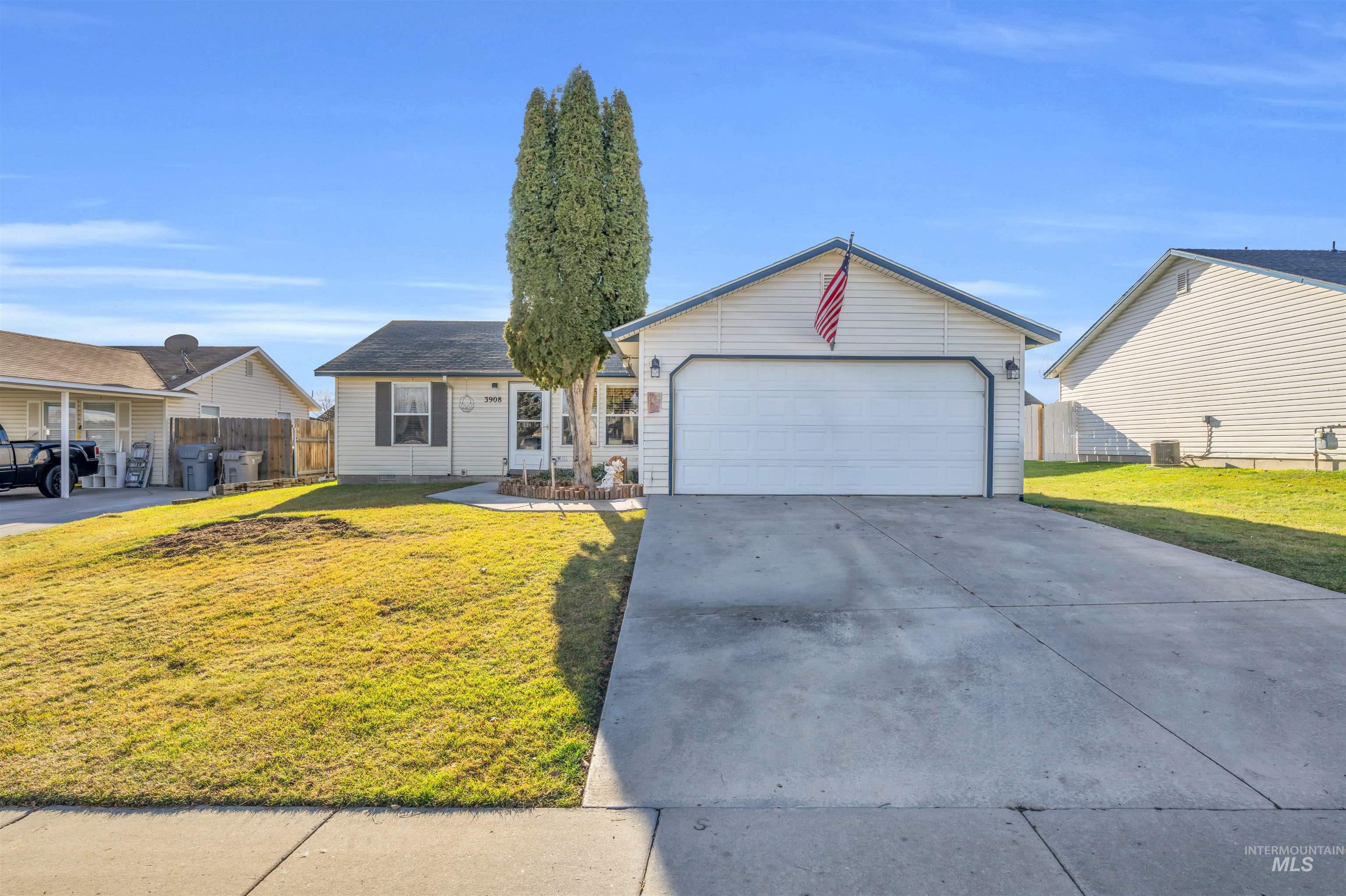 Ranch-style house with a garage and driveway