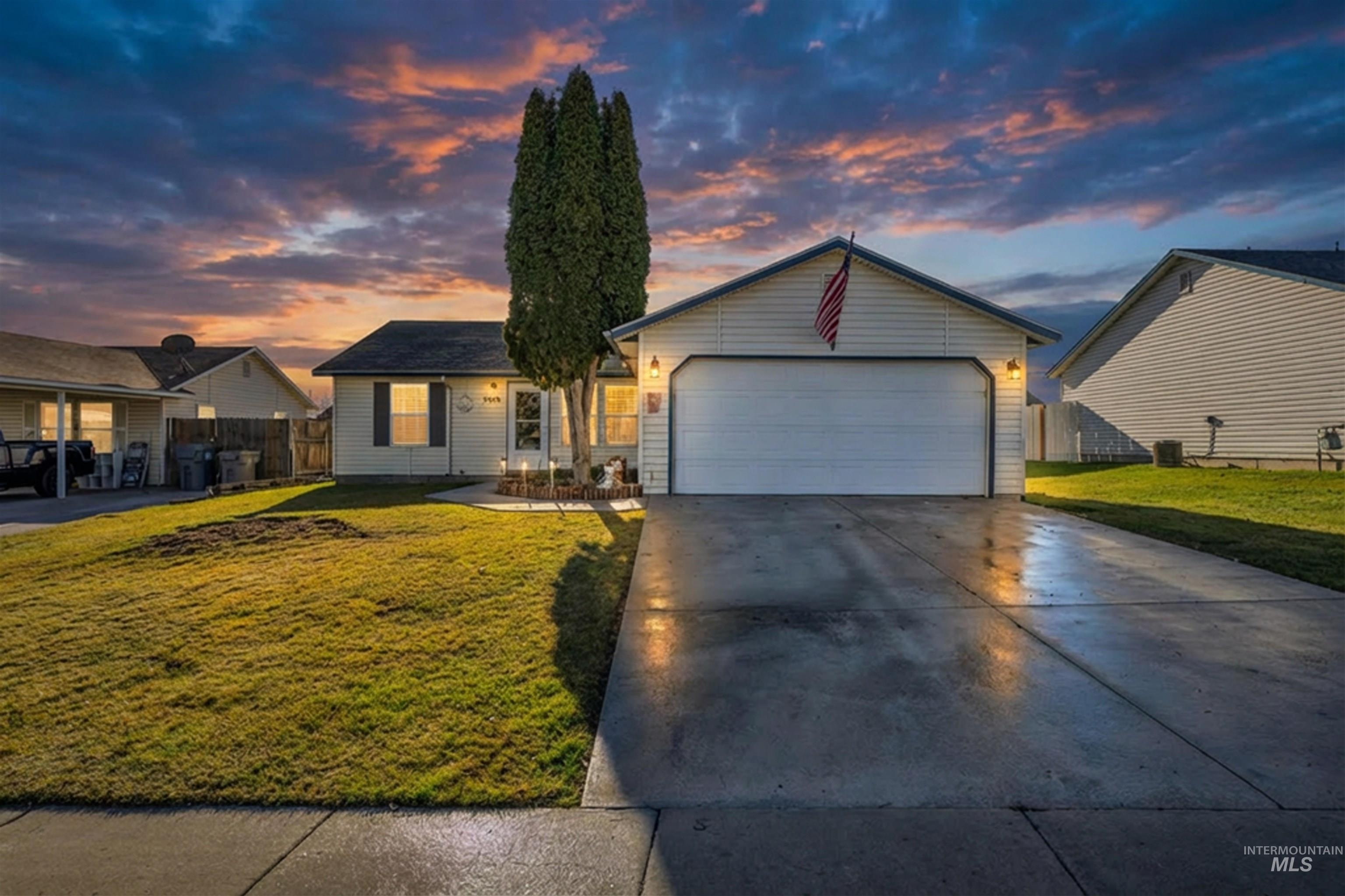 View of front of house featuring a garage and concrete driveway
