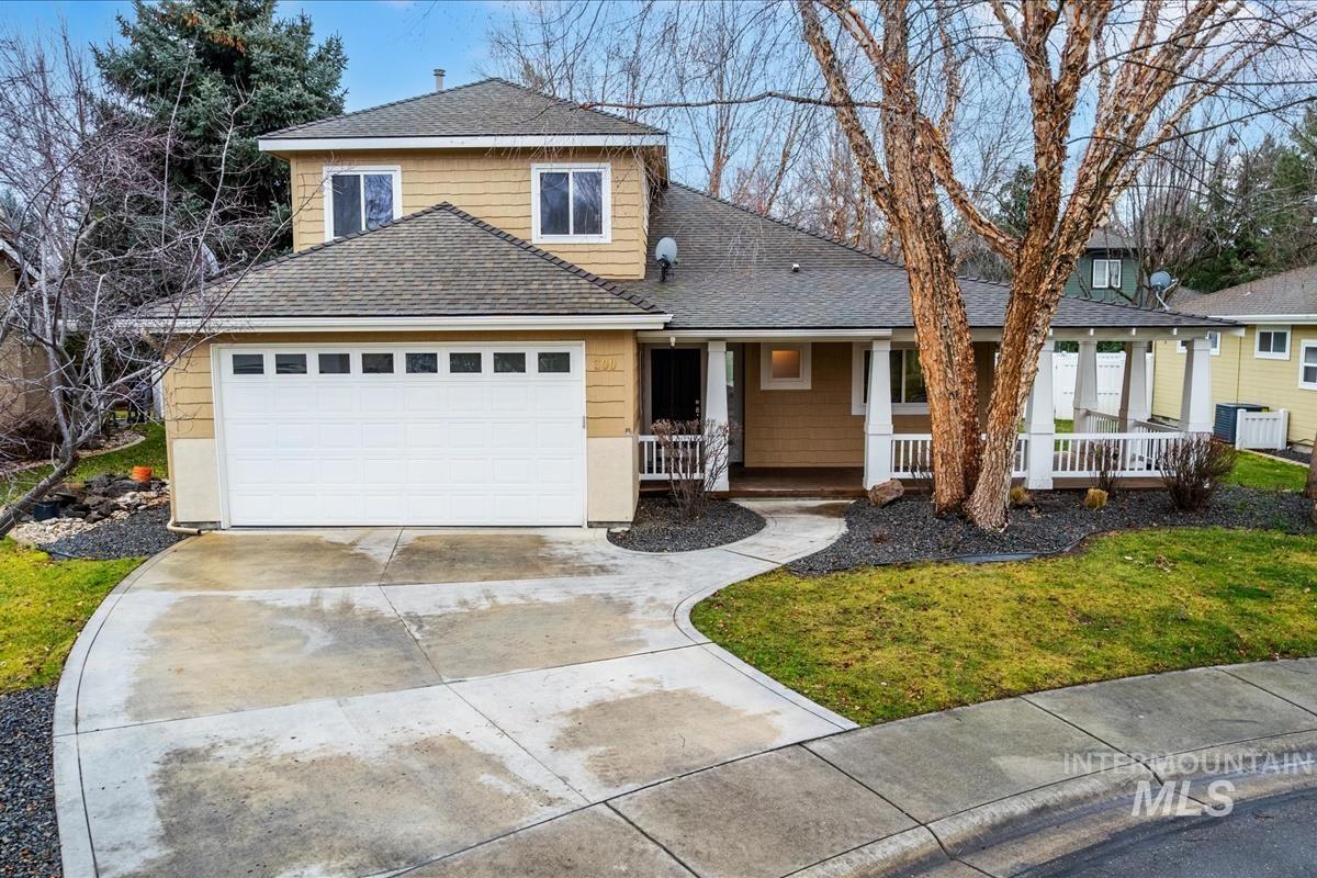 Traditional Craftsman-style home featuring covered porch, concrete driveway, a front yard, and a 2-car garage