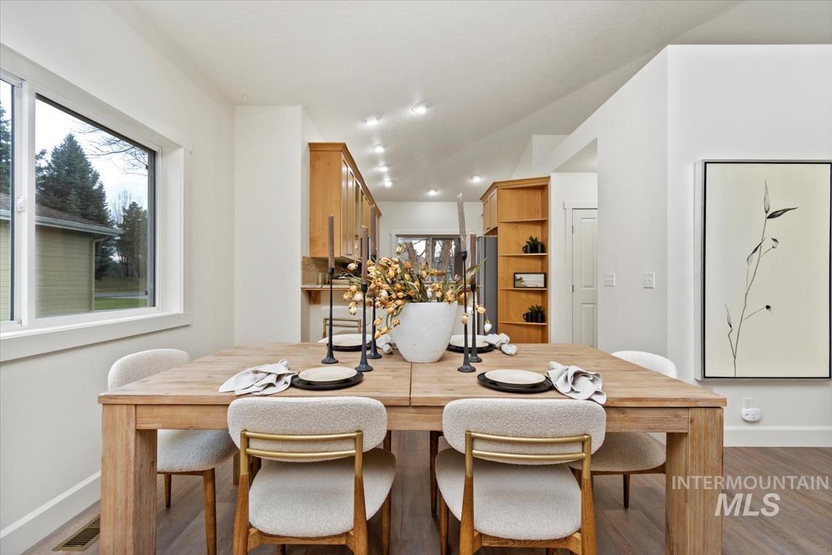 Dining space featuring wood finished floors and recessed lighting