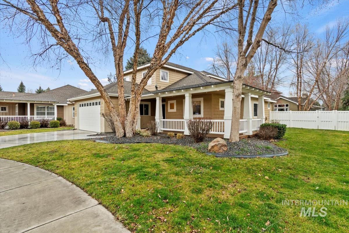 View of front of property with a porch, driveway, and garage