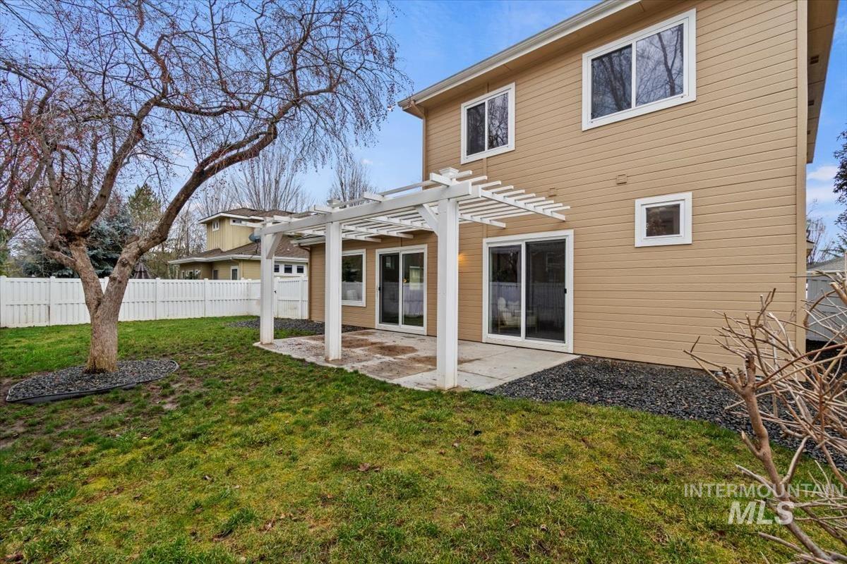 Back of house with a pergola and a patio