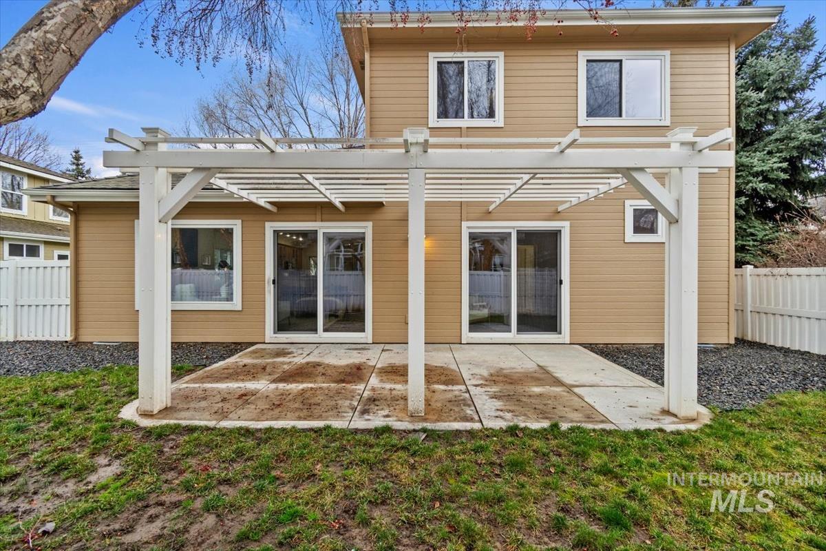 Back of property with a fenced backyard, a patio, and a pergola