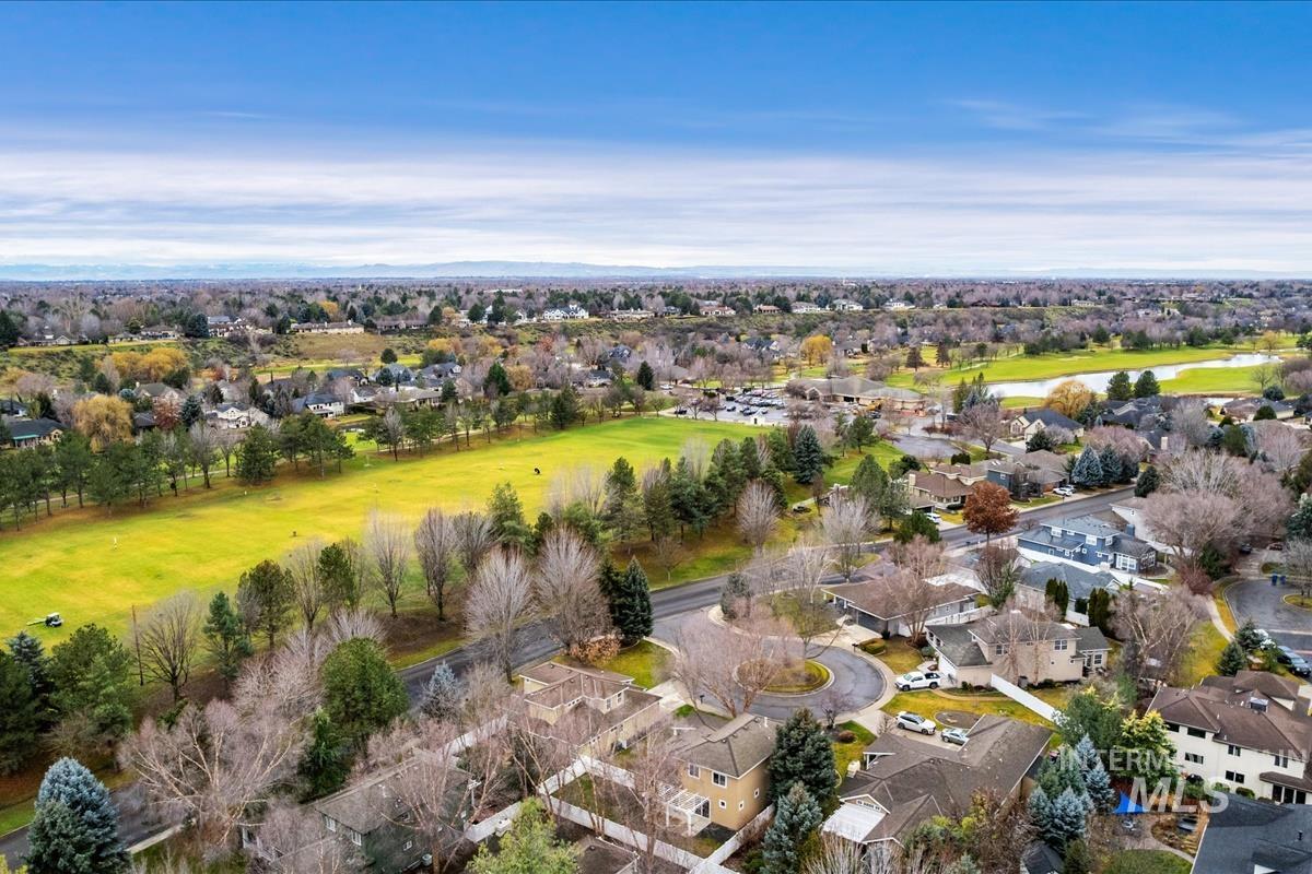 Aerial overview of property's location featuring nearby golf course & water features