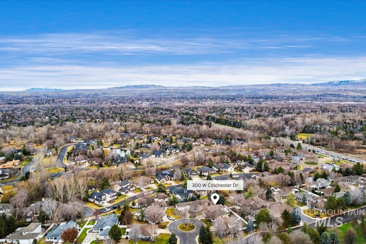 Aerial overview of property's location with nearby shopping, restaurants, and movie theatre