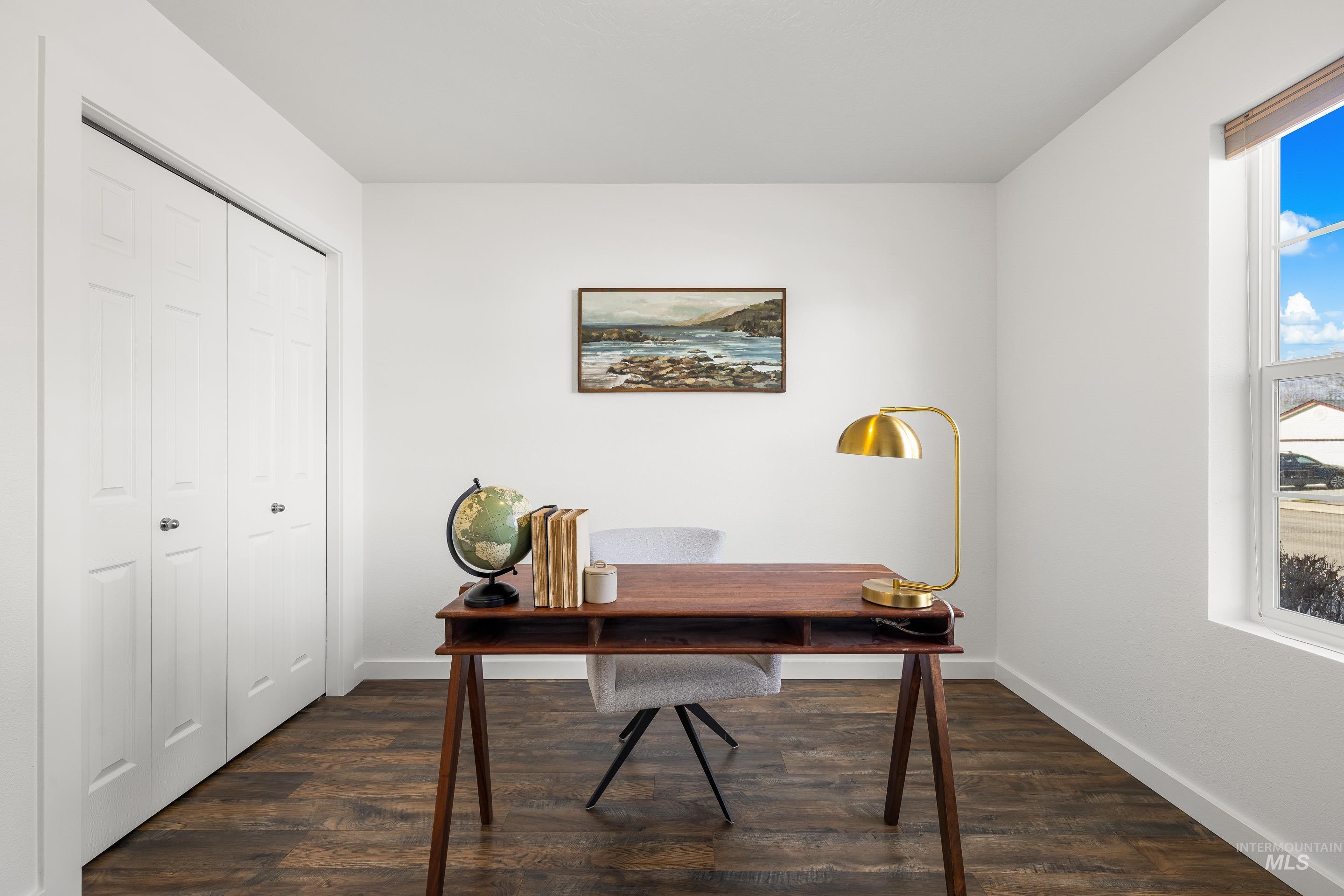 Office area featuring dark wood finished floors and baseboards