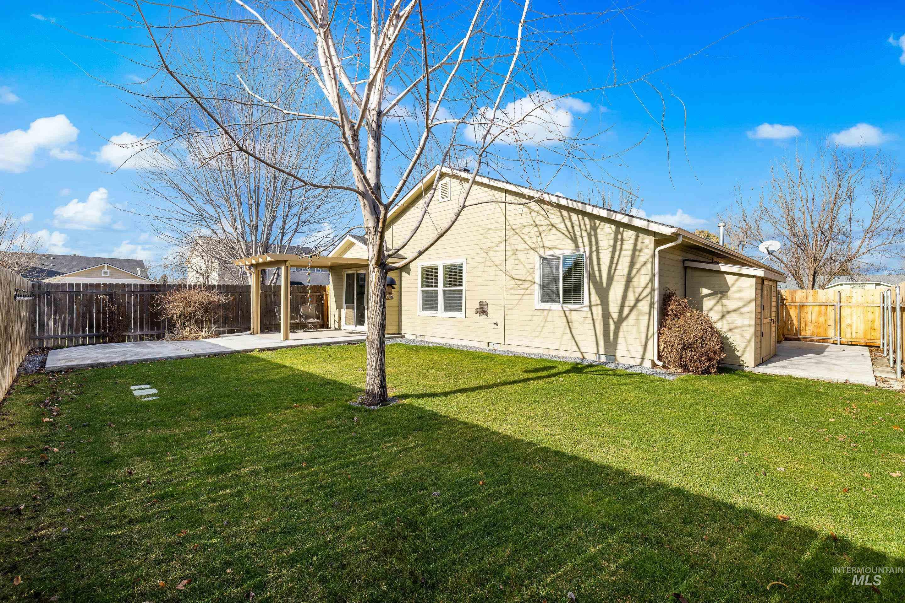 Rear view of house with a patio, a fenced backyard, and a pergola