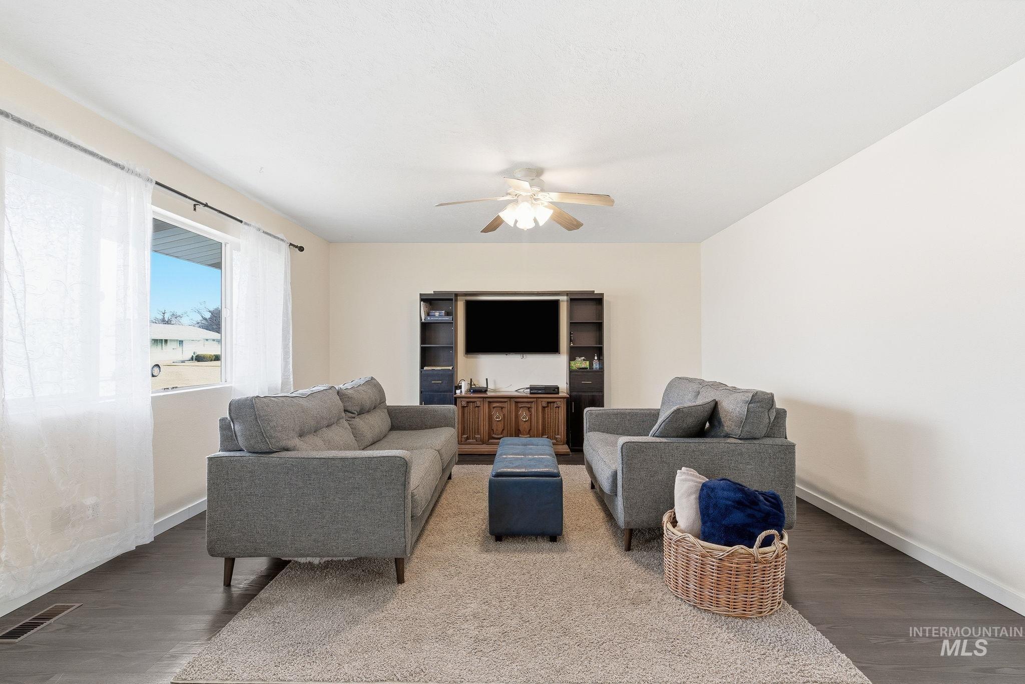 Living room featuring wood finished floors and ceiling fan