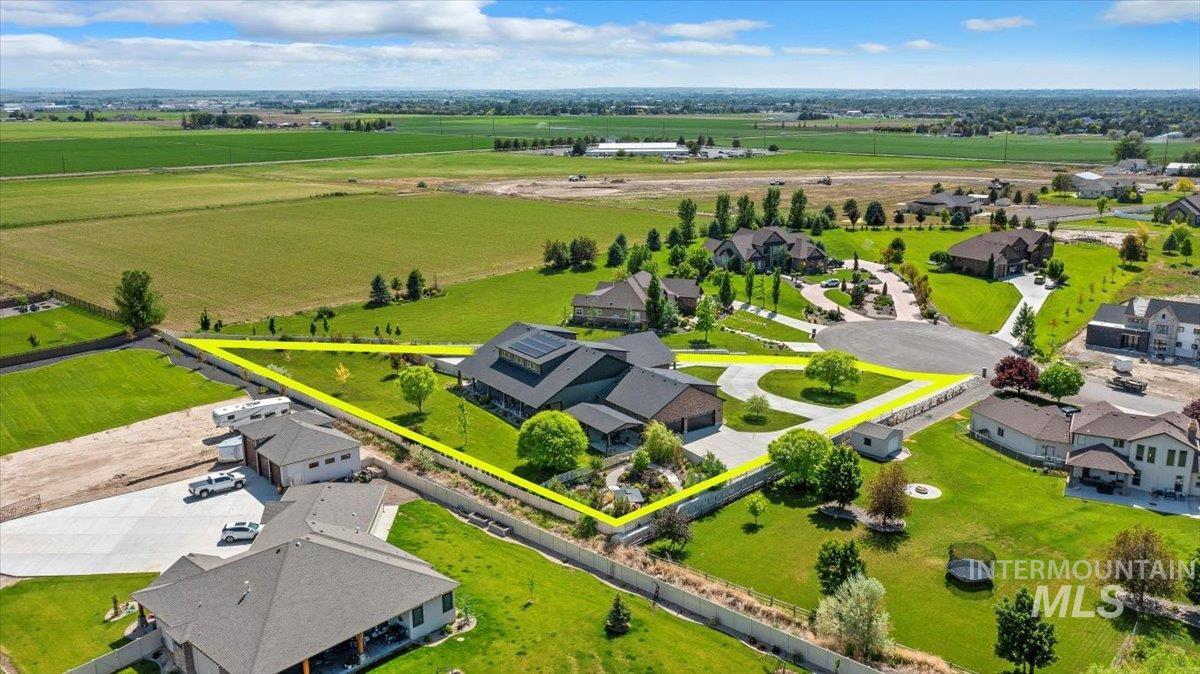 View of rural area featuring property parcel outlined and nearby suburban area