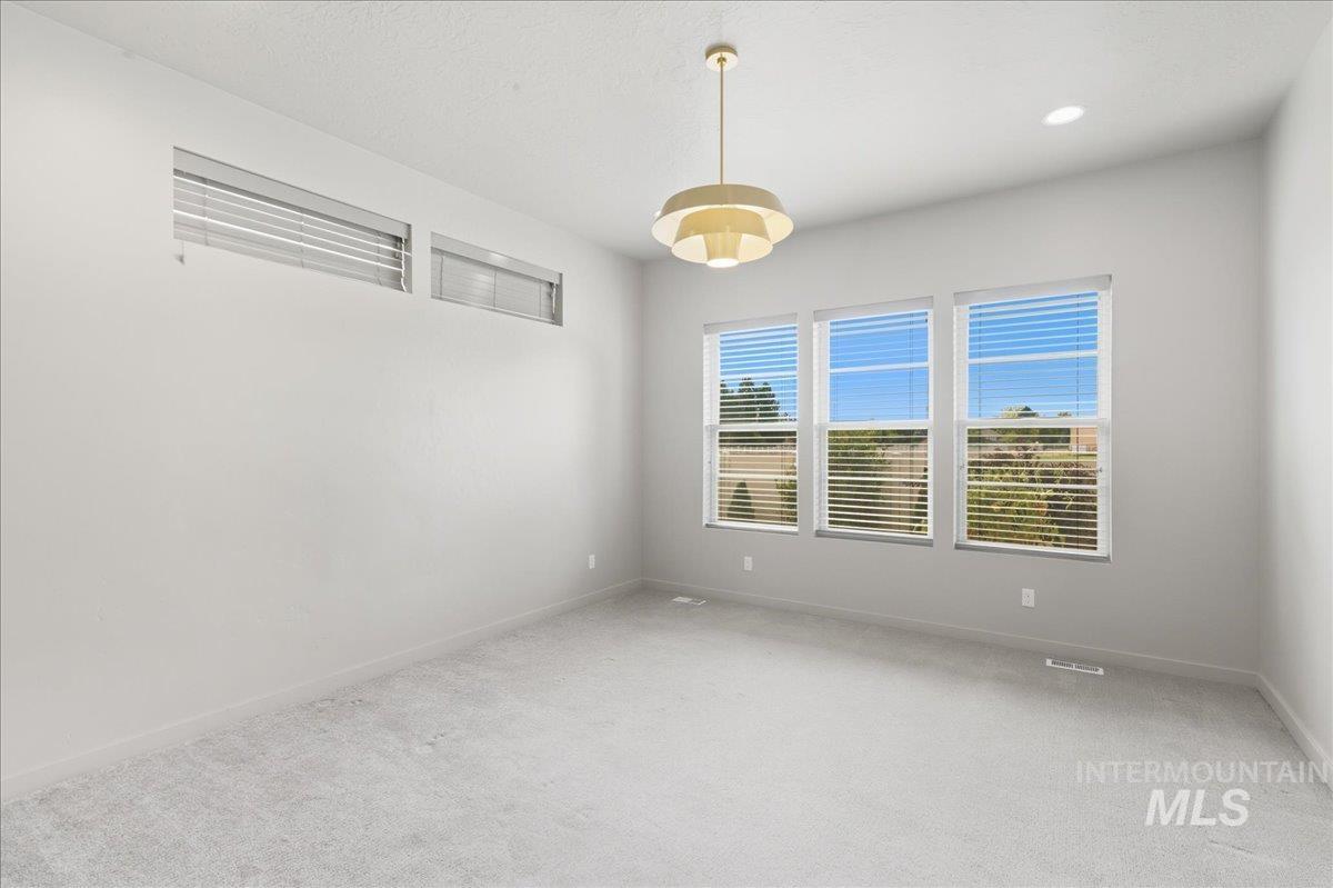 Empty room featuring carpet floors and baseboards
