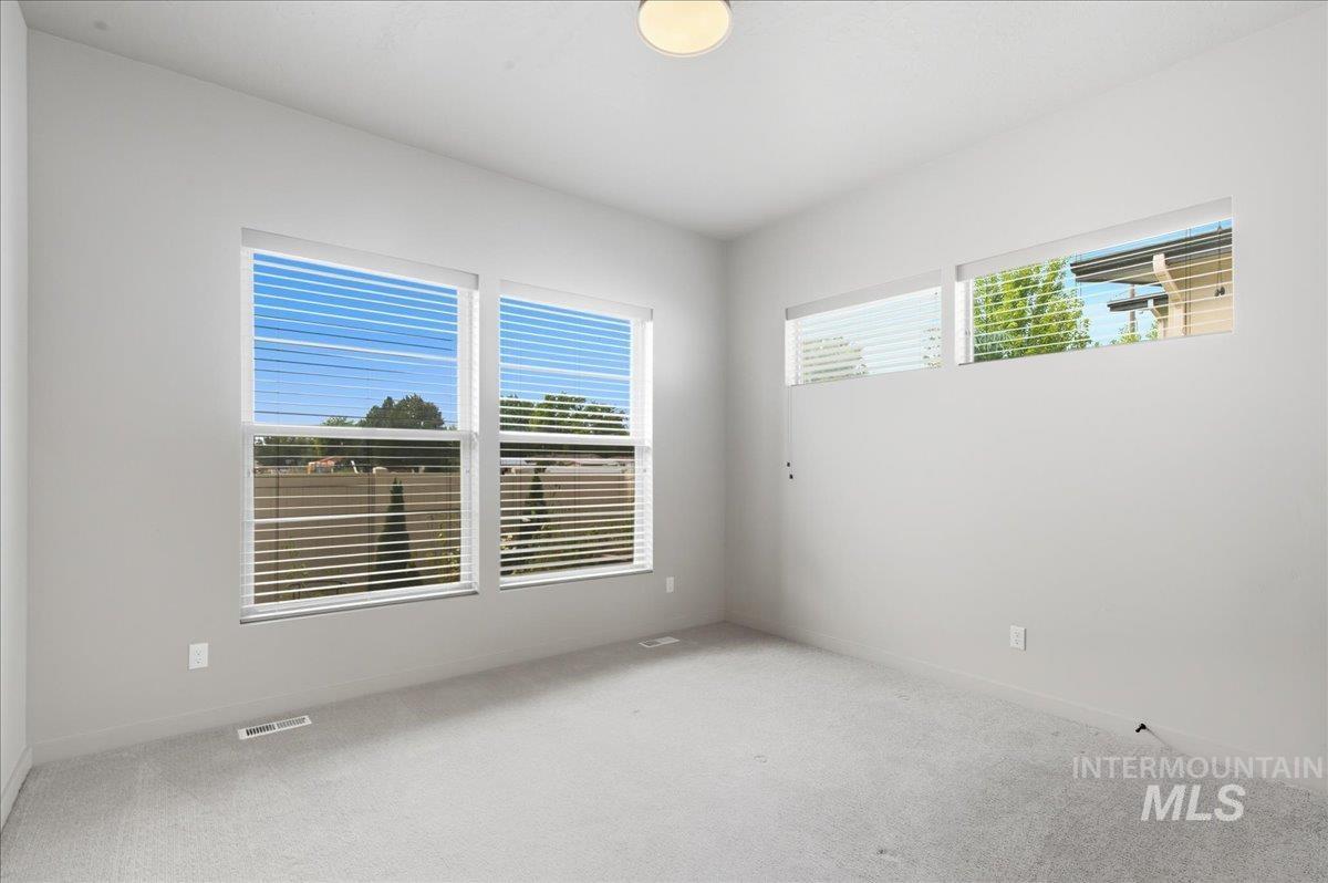Unfurnished room with light carpet and baseboards