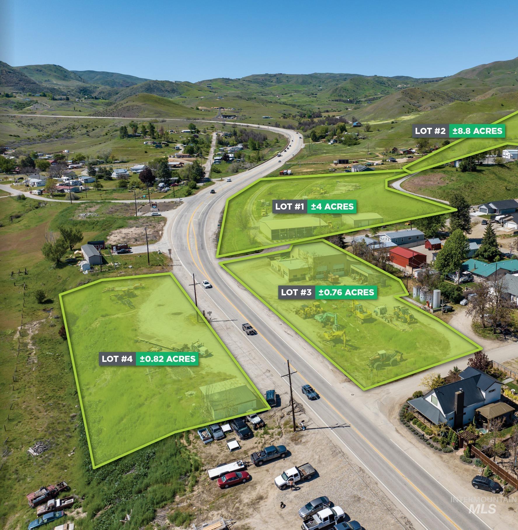 Aerial view of property and surrounding area featuring a mountainous background and property parcel outlined