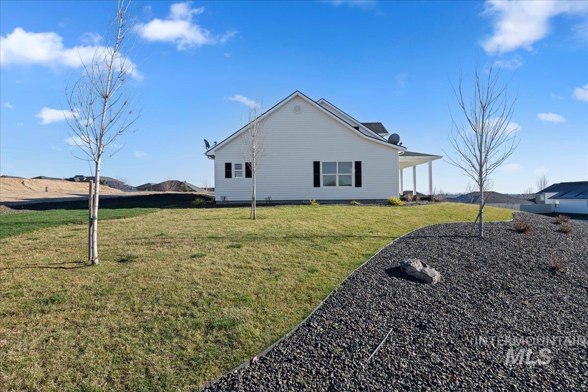 View of side of home featuring a lawn