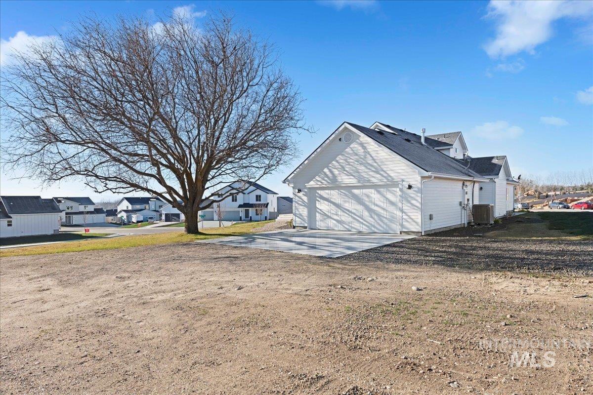 View of side of home with driveway and a residential view