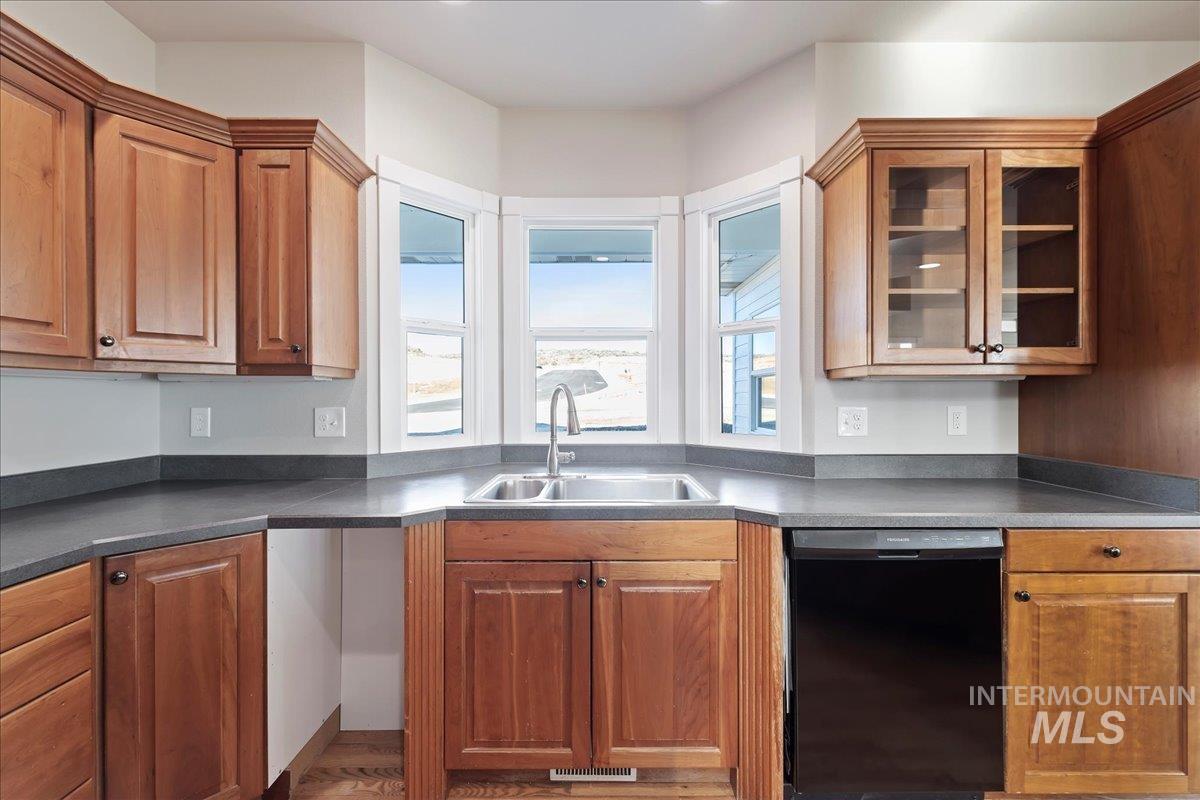 Kitchen featuring dishwasher and brown cabinetry