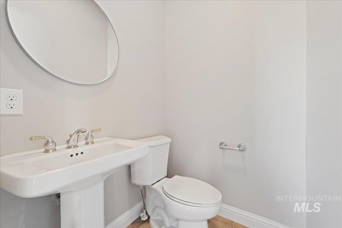 Bathroom featuring baseboards and tile patterned floors