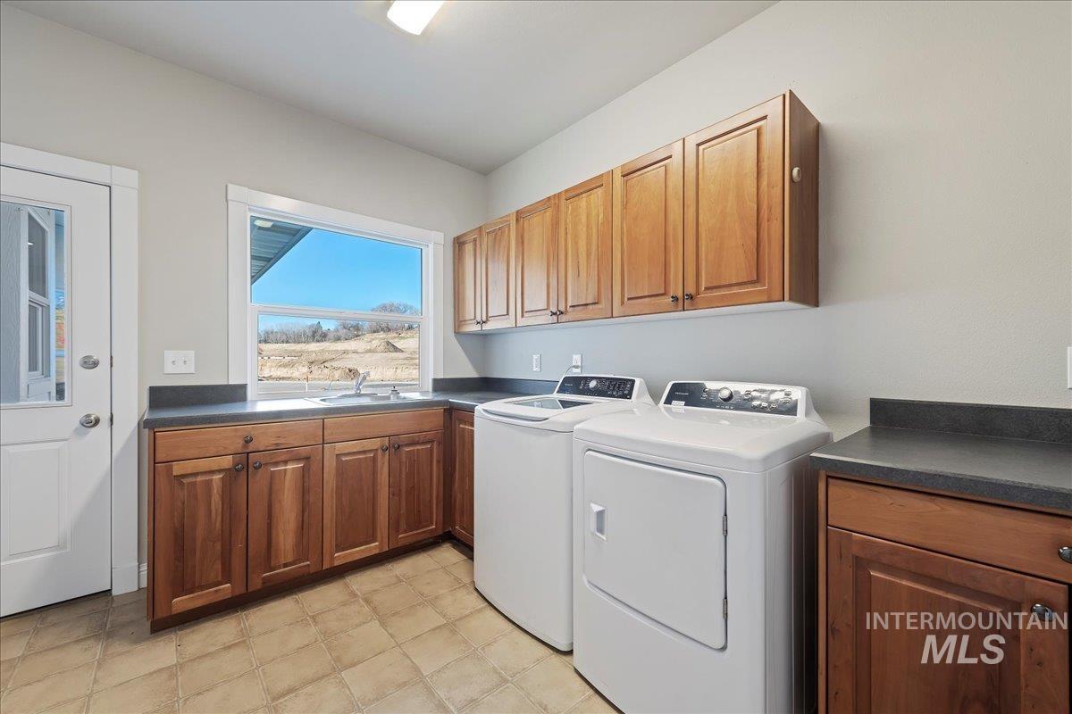 Laundry area featuring cabinet space and washing machine and clothes dryer