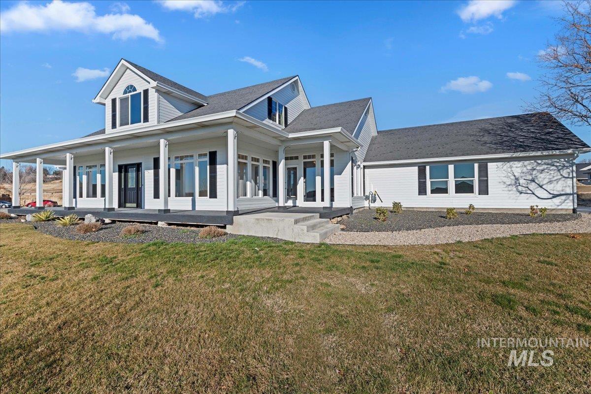 View of front of home featuring a porch and a front lawn