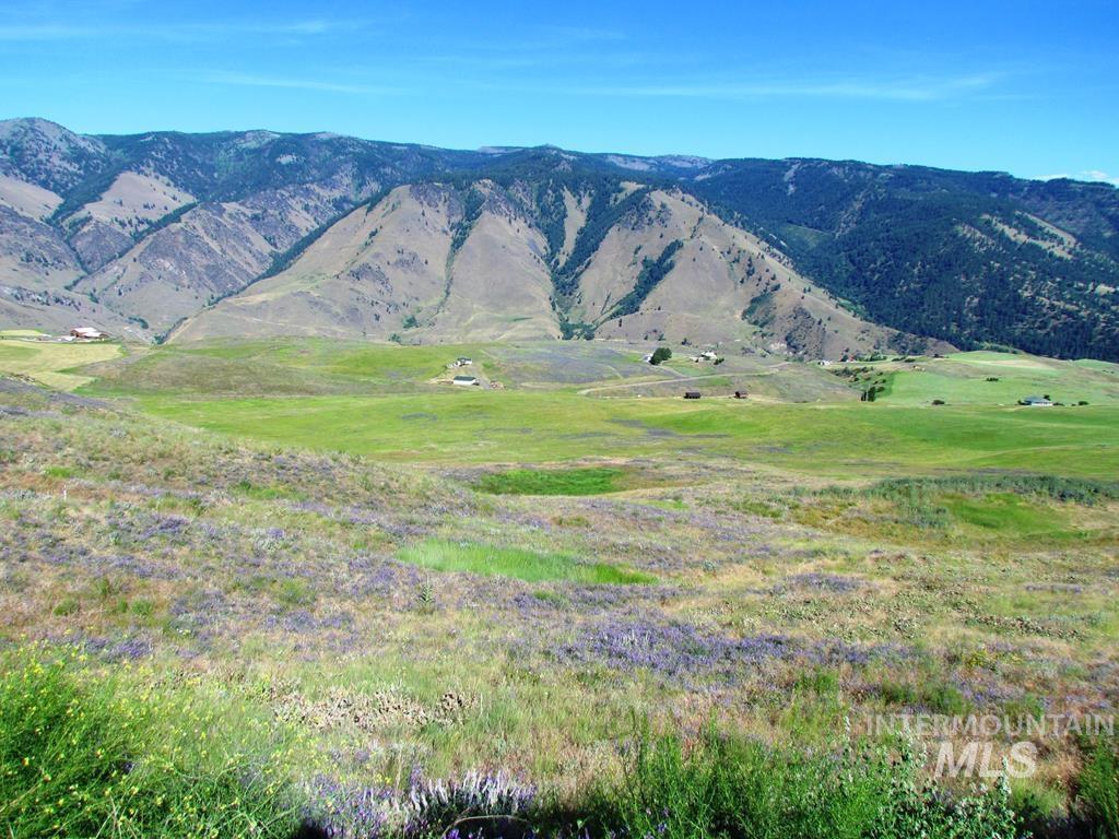 View of mountain backdrop with rural landscape