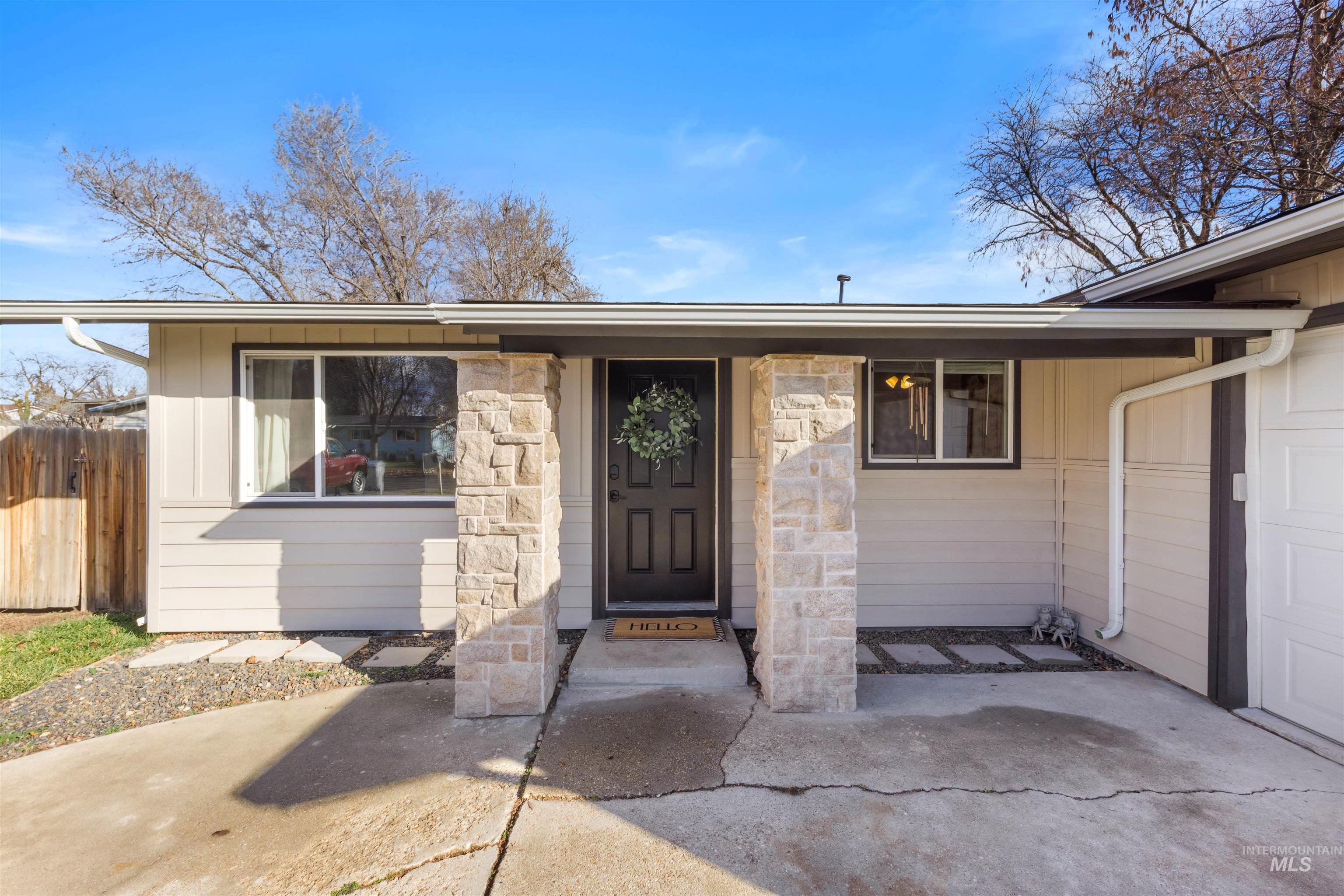 View of exterior entry featuring stone siding