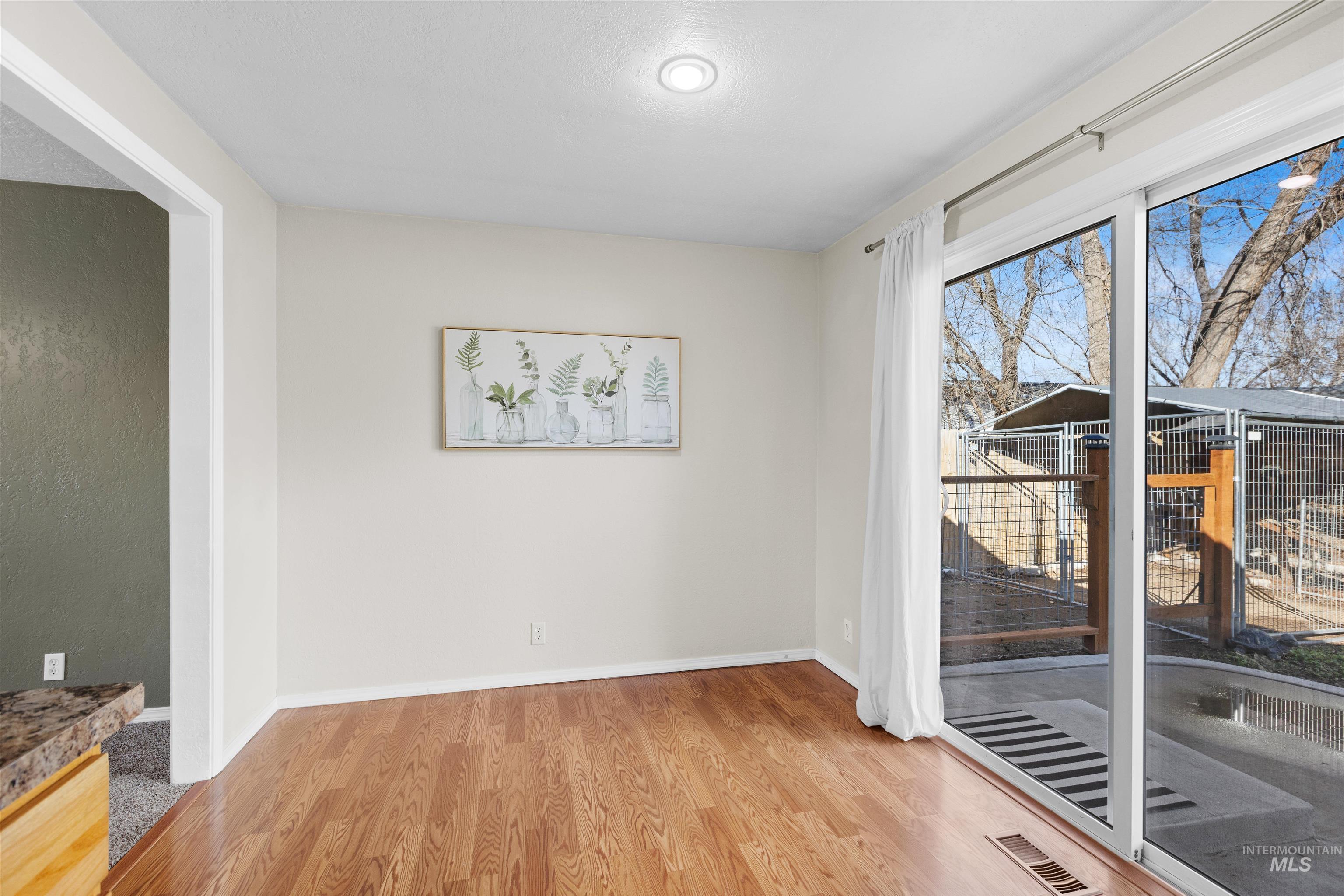 Unfurnished dining area with light wood-type flooring and stairs