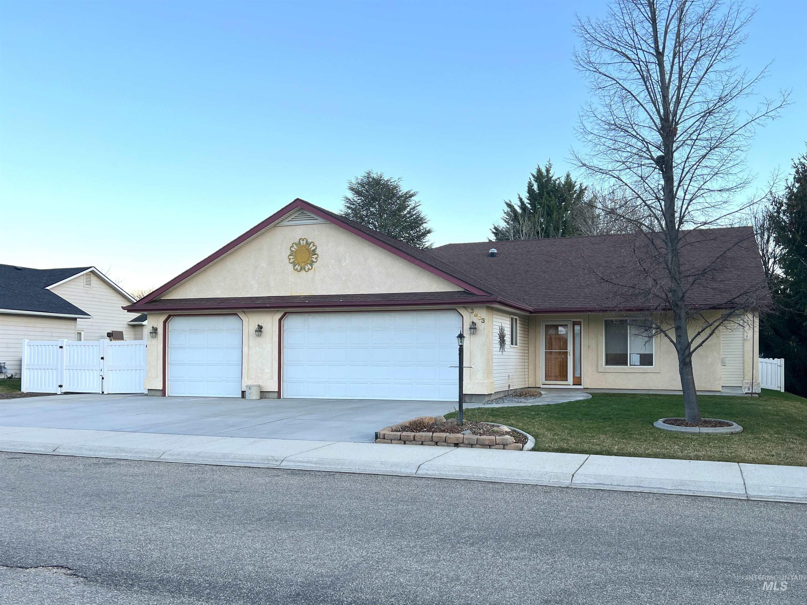 Single story home featuring driveway, a garage, stucco siding, and a porch