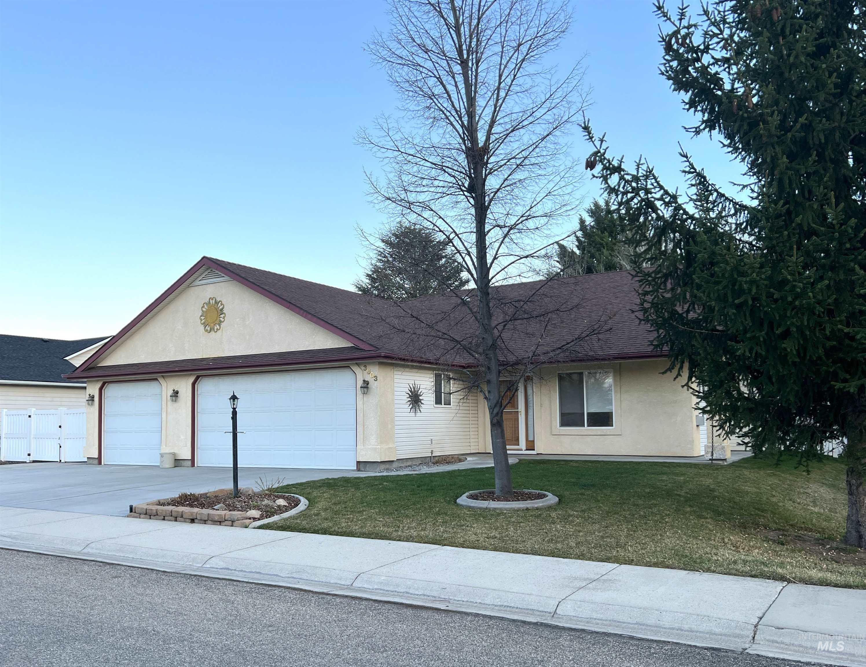 Single story home with concrete driveway, a front lawn, stucco siding, and an attached garage