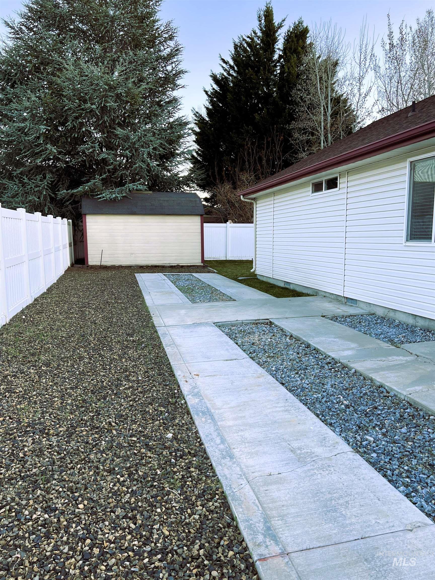 Fenced backyard featuring a RV pad