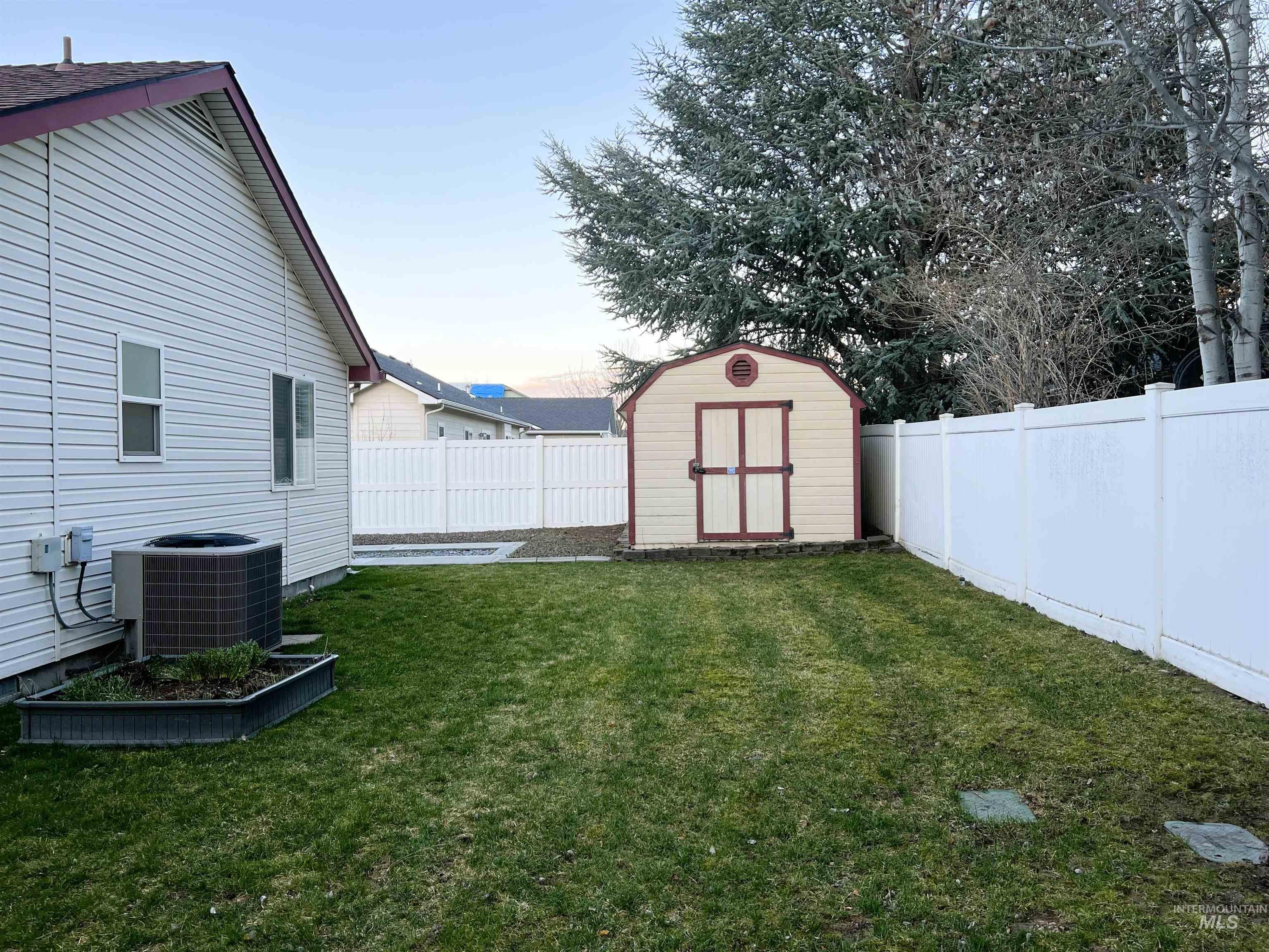 Fenced backyard with a shed