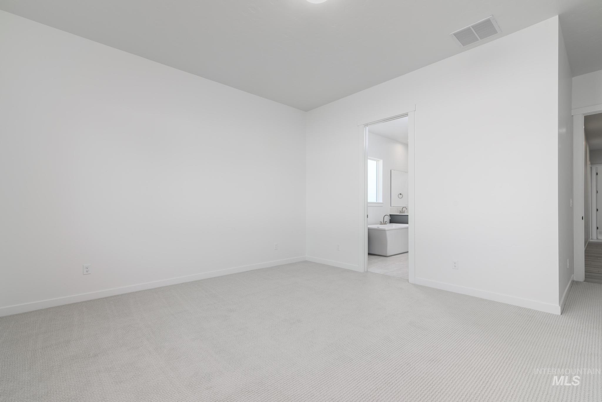 Unfurnished room with light carpet