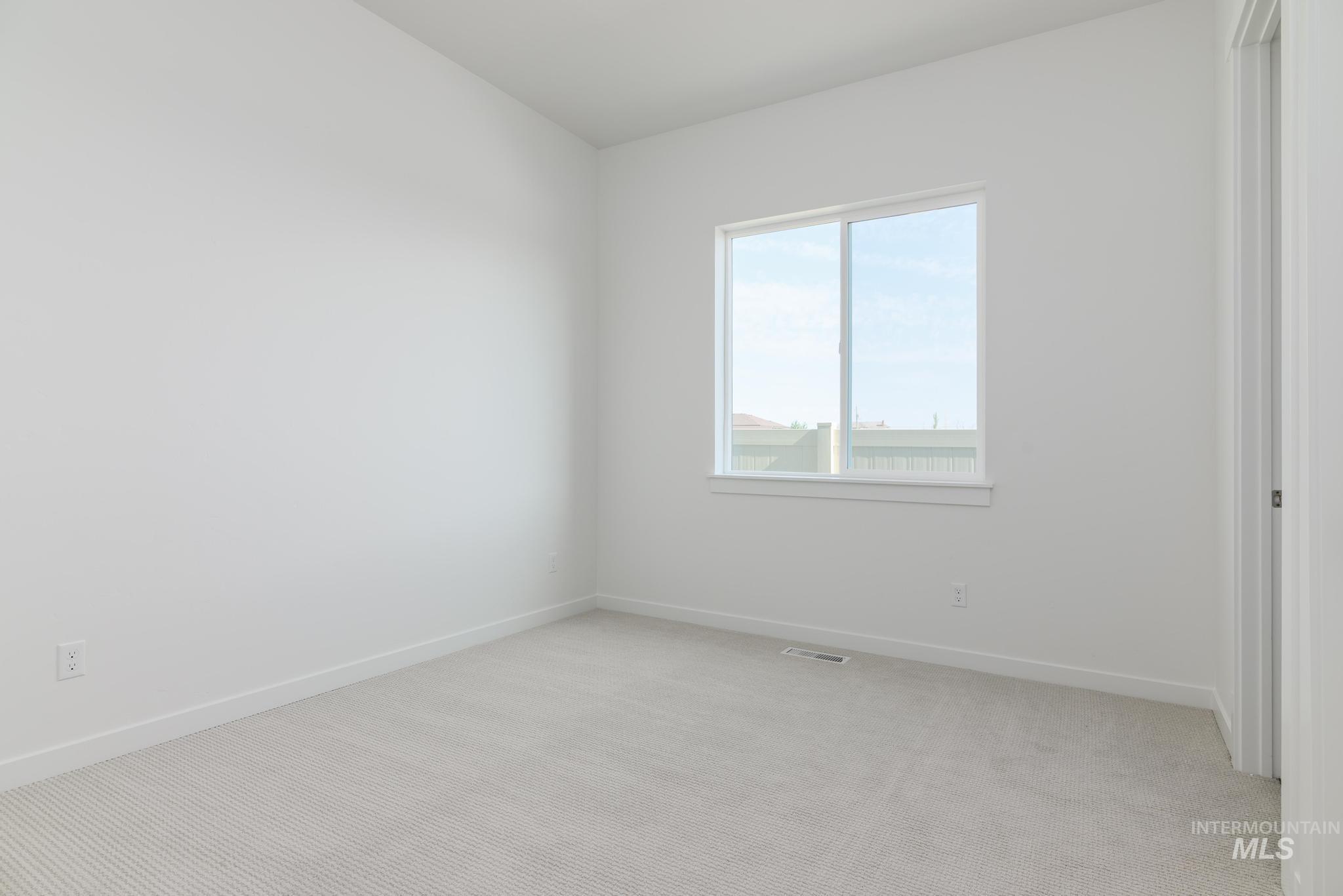 Unfurnished room featuring light colored carpet
